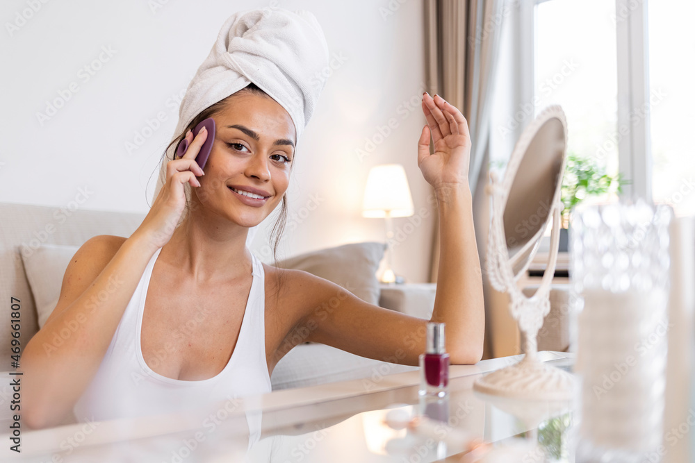 Young woman washing face with silicone pink brush and cleansing foam. Attractive smiling girl using pink silicone cleansing facial brush. Beautiful woman clean face with cleansing brush. Young woman washing face with silicone pink brush and cleansing foam. Attractive smiling girl using pink silicone cleansing facial brush. Beautiful woman clean face with cleansing brush.