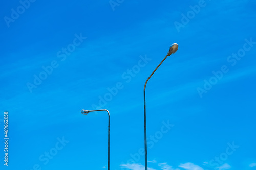 Streetlight electric lamppost on blue background horizontal