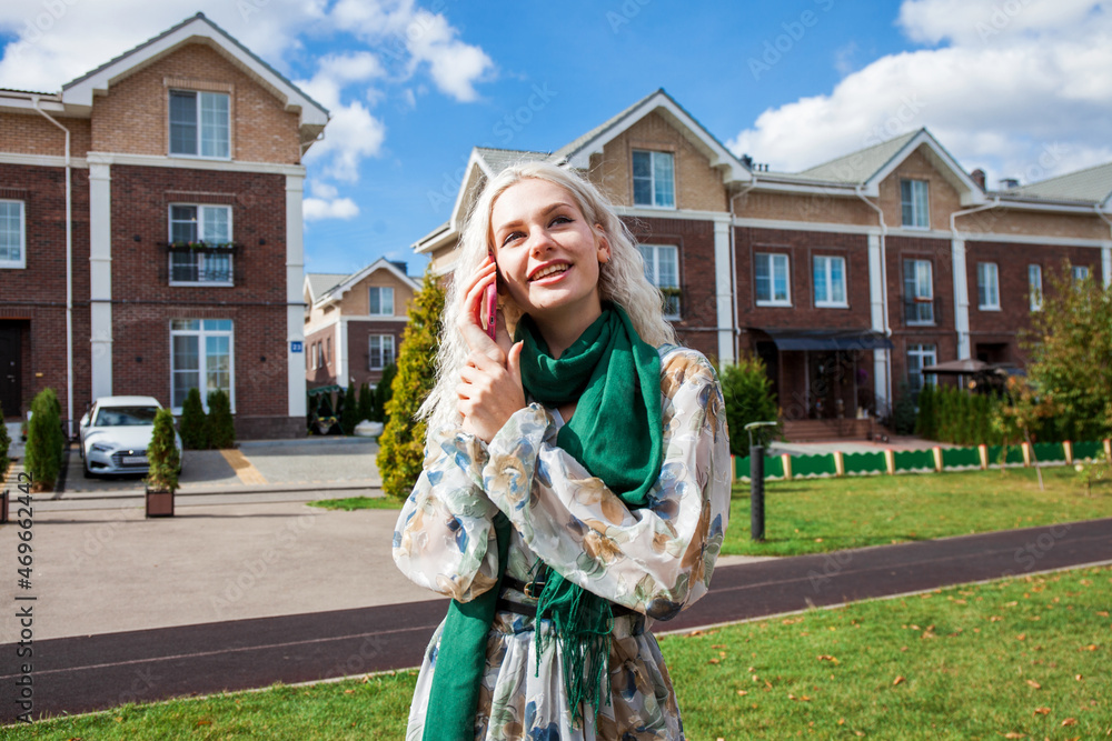Fototapeta premium Portrait of young blonde woman in white dress