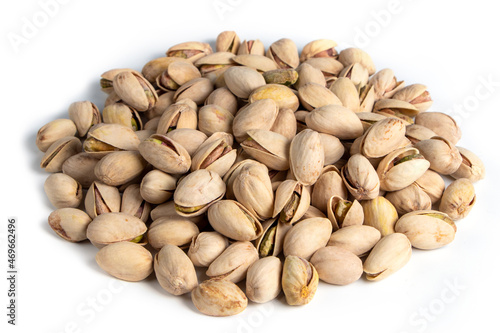 Pile of pistachios in the peel close-up on a white background. Isolated.