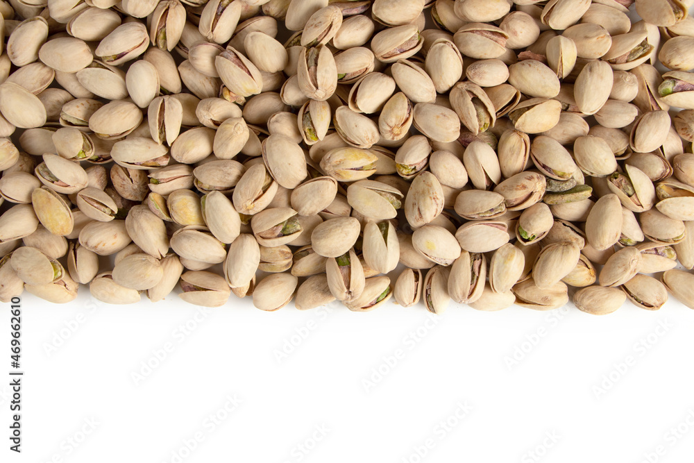 Roasted and salted pistachios in shell on white background copy space Roasted and salted pistachios in shell on white background copy space