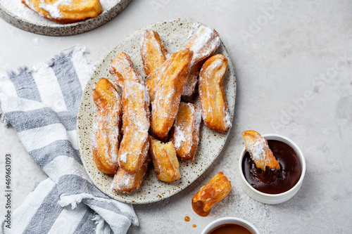 churros in with caramel and chocolate sauces photo