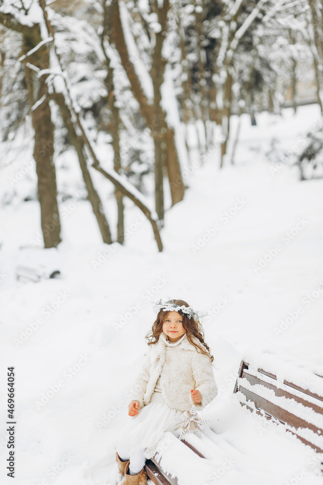 Portrait of a girl walking in the winter outdoors. Playing with snow. children outdoor Portrait of a girl walking in the winter outdoors. Playing with snow. children outdoor