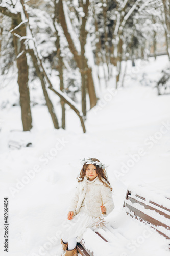 Portrait of a girl walking in the winter outdoors. Playing with snow. children outdoor