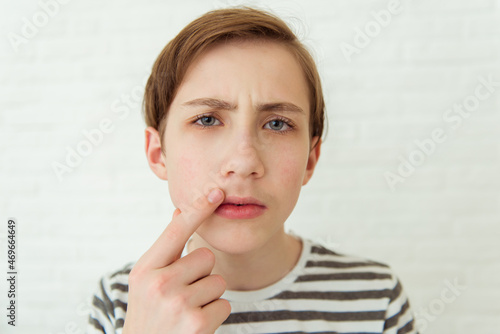 Принти на полотні Teen boy looks at his first mustache in mirror, puberty period, early adulthood