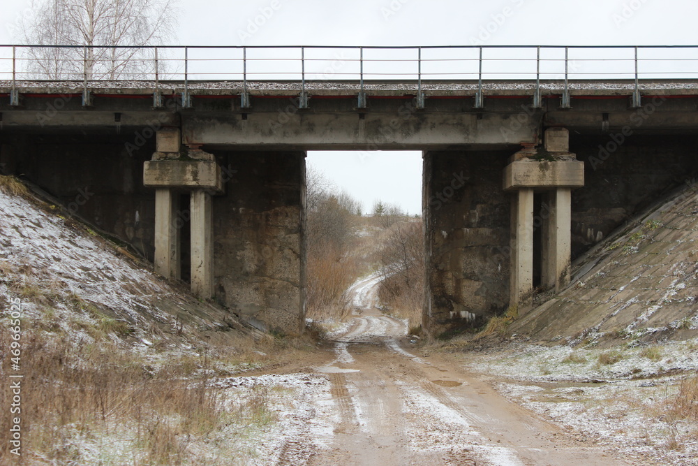road under a railway bridge, concrete bridge over a country road
