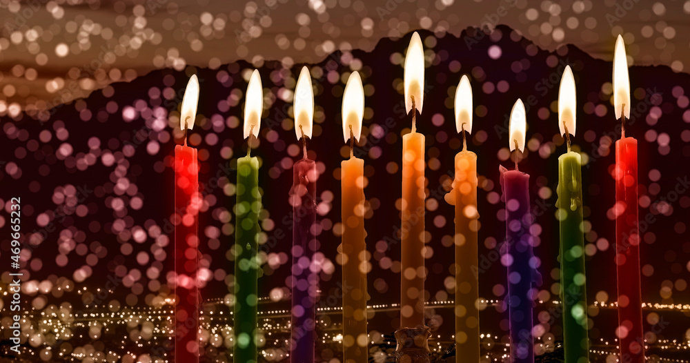 Burning festive wax candles are traditional symbols of Hanukkah Holiday of Light, selective focus on candles, blurred background of mountains and digitally generated festive bokeh Burning festive wax candles are traditional symbols of Hanukkah Holiday of Light, selective focus on candles, blurred background of mountains and digitally generated festive bokeh