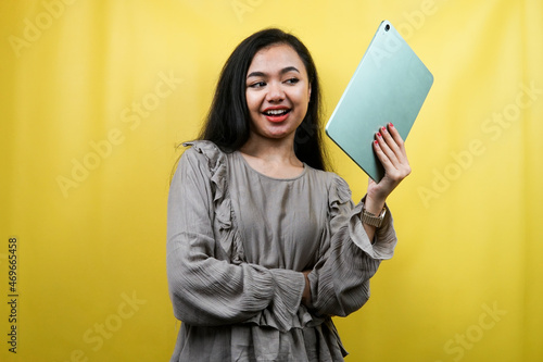 Beautiful young woman with hand holding tablet, presenting something, promoting product, cheerful and confident, advertisement, isolated