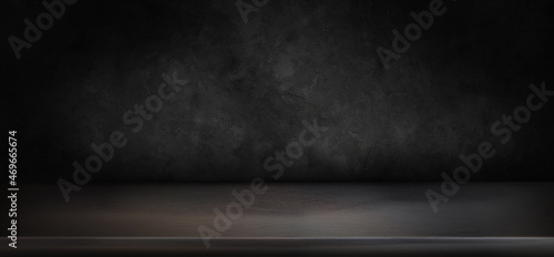 empty black table top with dark concrete rough background subtle lighting