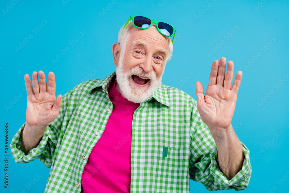 Naklejka premium Photo of cheerful happy cool positive old granddad weekend vacation summer mood isolated on blue color background