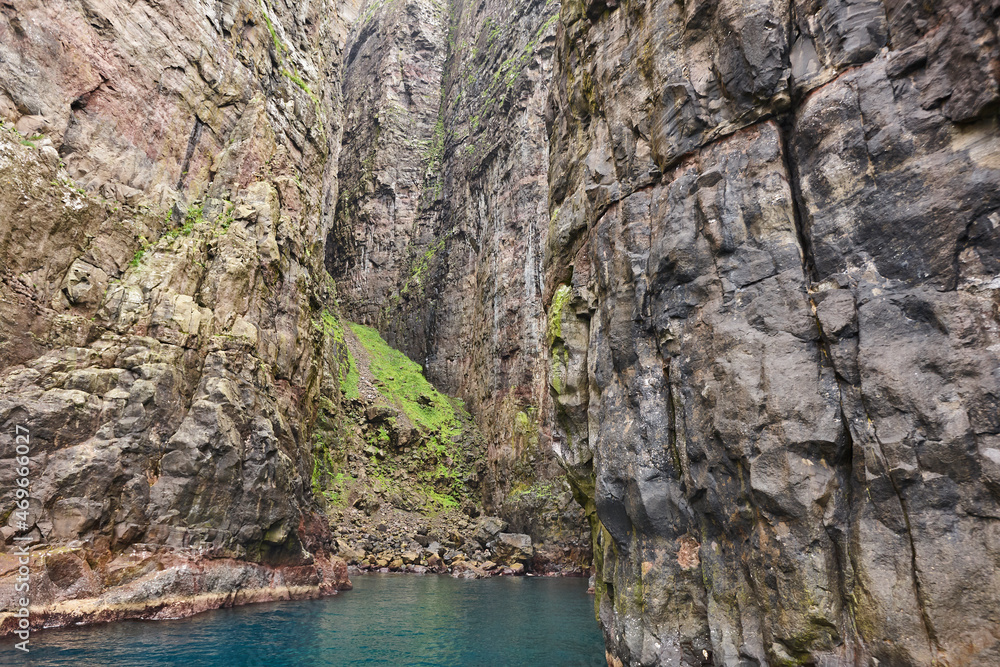 Rocky coastline cliffs landscape in Faroe islands. Vagar island