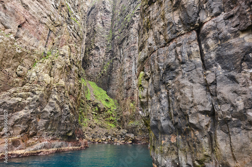 Rocky coastline cliffs landscape in Faroe islands. Vagar island