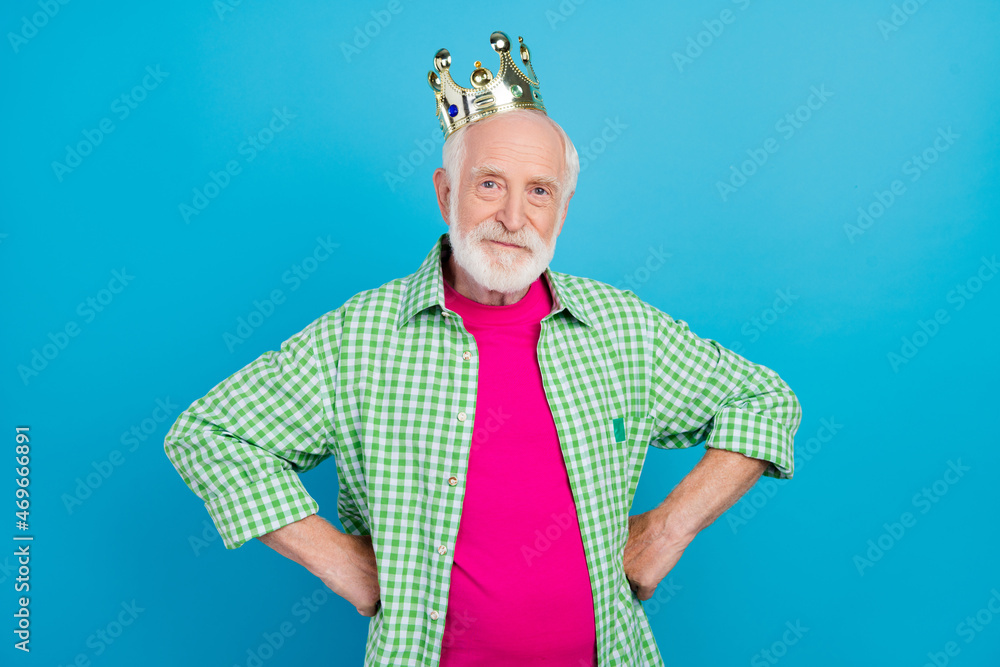 Fototapeta premium Photo of old cool charming granddad hold hands waist wear golden crown isolated on pastel blue color background