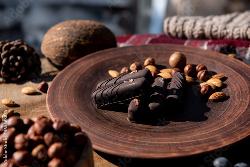 Chocolate with caramel and nuts. Copy space. Close-up. Soft focus background.