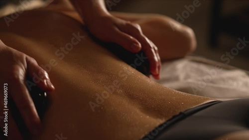 Wallpaper Mural The masseuse does a back massage using special stones. Back massage with stones. Beautiful young woman undergoing treatment with hot stones in spa salon. Torontodigital.ca