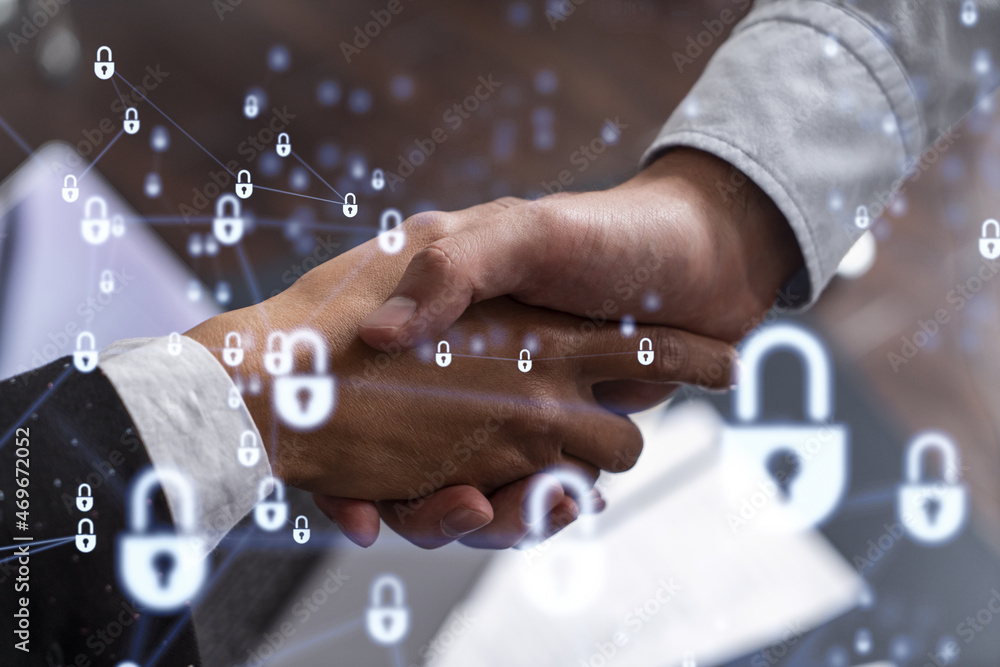 Handshake of two businesspeople who are negotiated the project to protect cyber security of international company. Padlock Hologram icons. Woman in business.