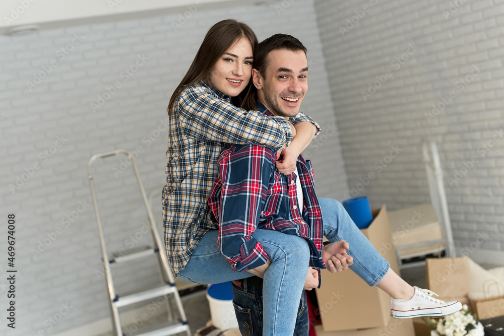 Happy couple is having fun in new house at moving day. Happy couple is having fun in new house at moving day.