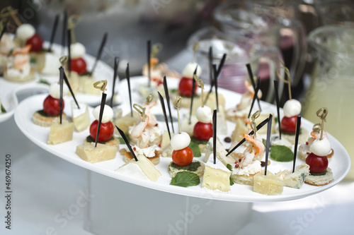 Catering table buffet dinner  beautifully decorated banquet with variety of different food snacks and appetizers on corporate birthday party event or wedding reception  canape  delicatessen setting