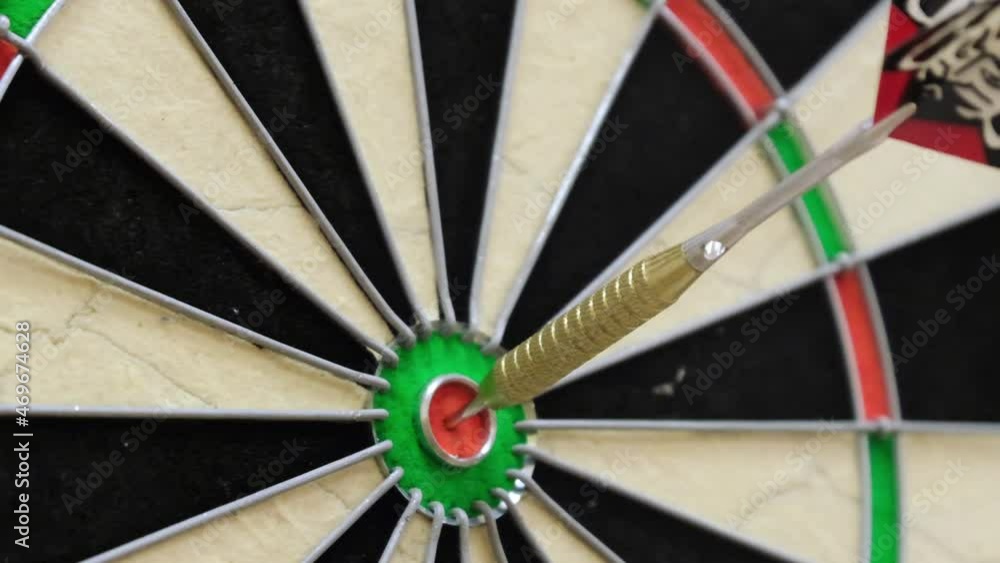 metal-tipped darts stuck in a competition dartboard metal-tipped darts stuck in a competition dartboard