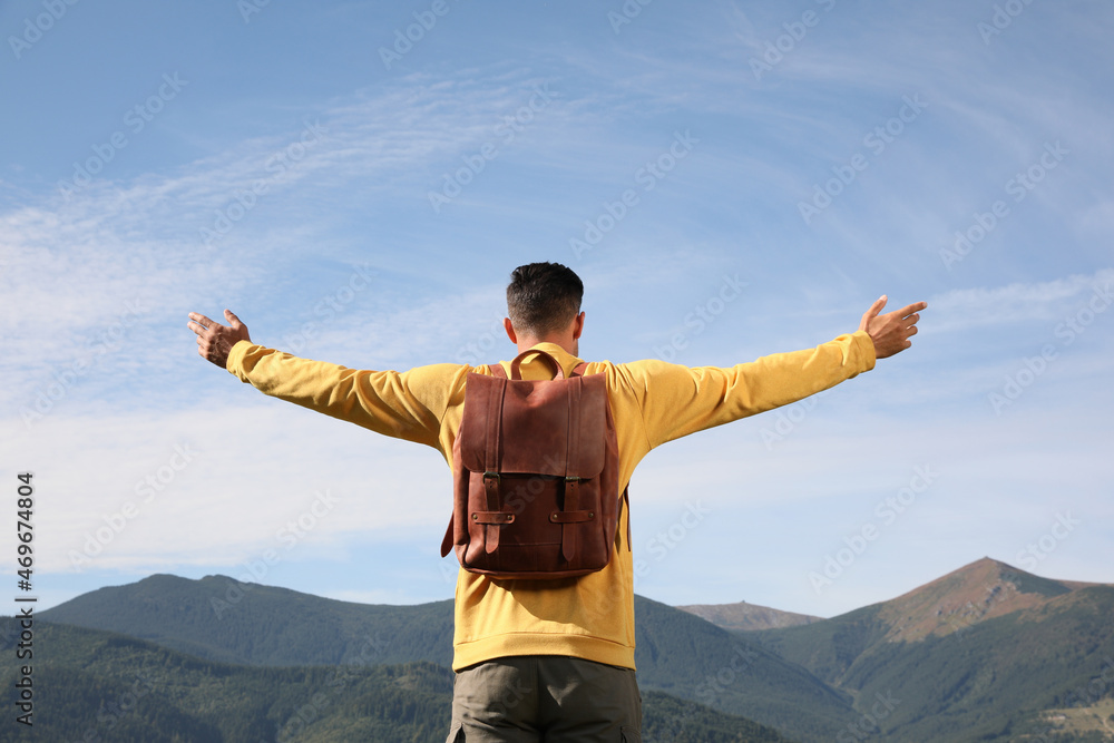 Man enjoying beautiful mountain landscape, back view Man enjoying beautiful mountain landscape, back view