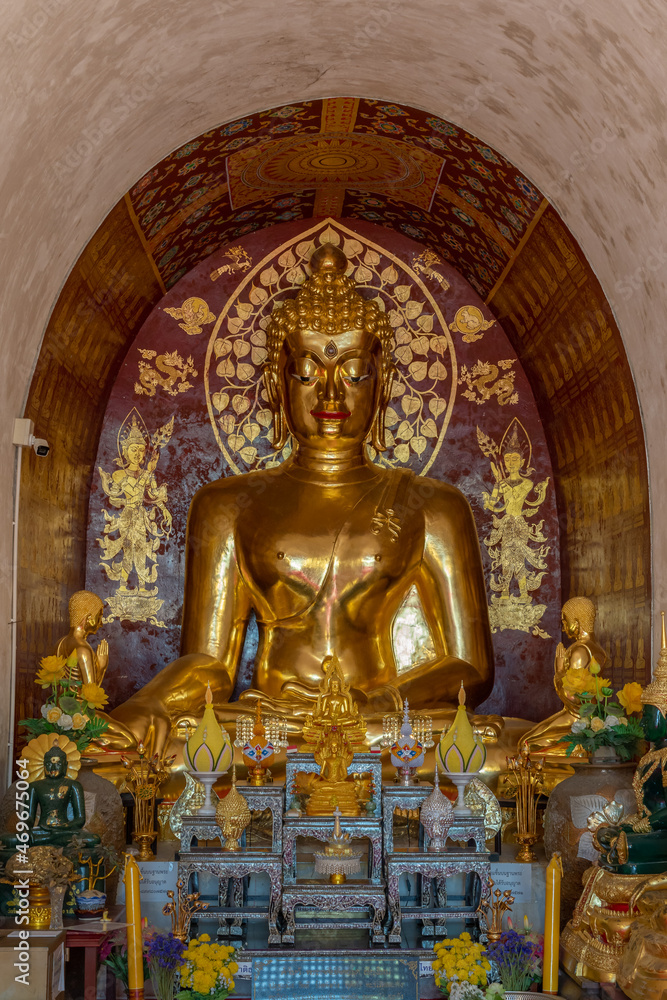 Ancient Buddha statues with beautiful red and gold stencil decoration background inside main viharn, at historic Wat Chet Yot or Wat Jed Yod buddhist temple, Chiang Mai, Thailand Ancient Buddha statues with beautiful red and gold stencil decoration background inside main viharn, at historic Wat Chet Yot or Wat Jed Yod buddhist temple, Chiang Mai, Thailand