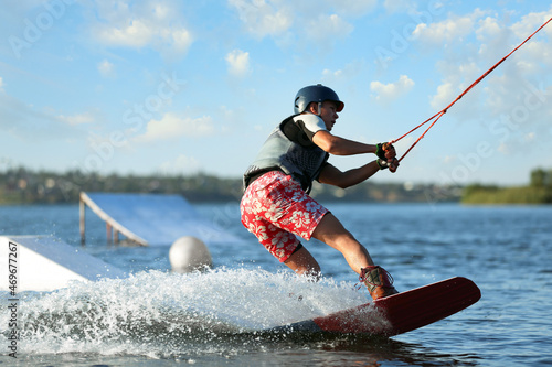 Fotografía Teenage boy wakeboarding on river. Extreme water sport