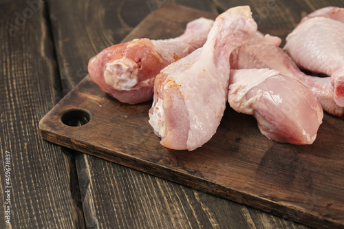 Chicken thighs on a wooden table. Raw chicken meat.