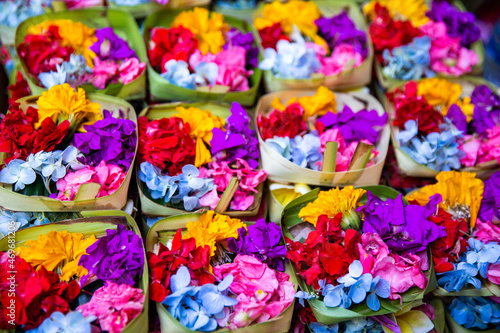 Traditional balinese offerings to gods in Bali with flowers.