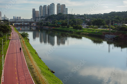 polluted Pinheiros river in Sao Paulo, Brazil. bike lane and buildings cityscape photo