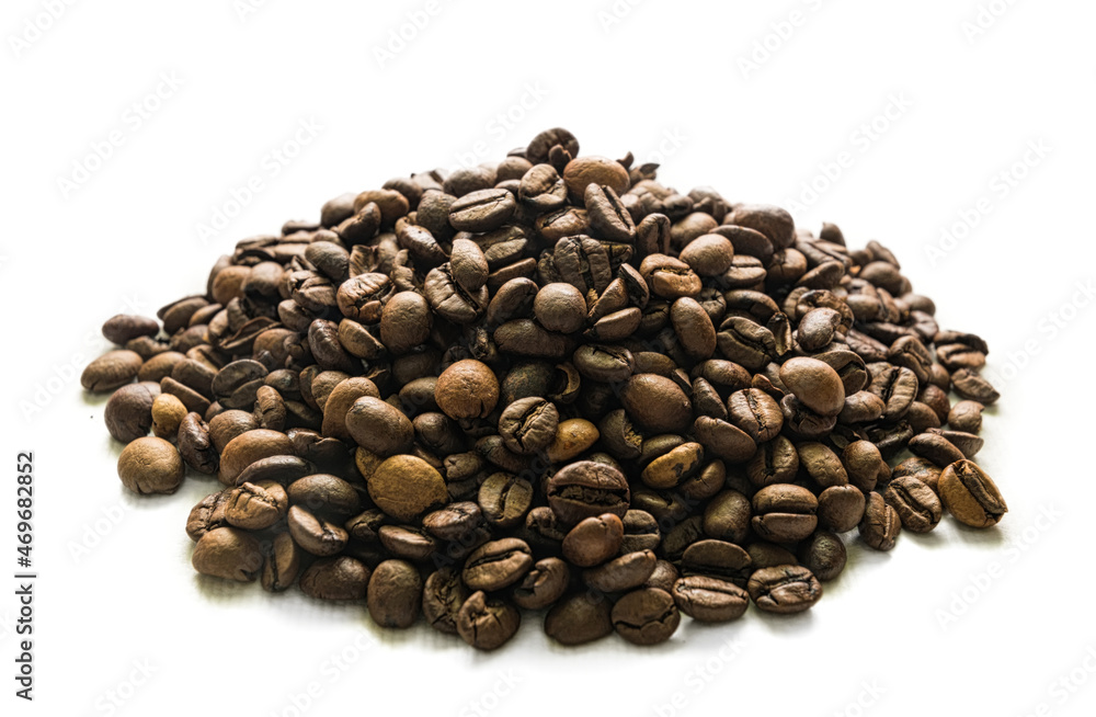 Handful of roasted coffee beans on white background