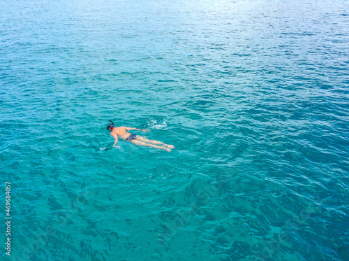 A man snorkeling in the ocean in Thailand.