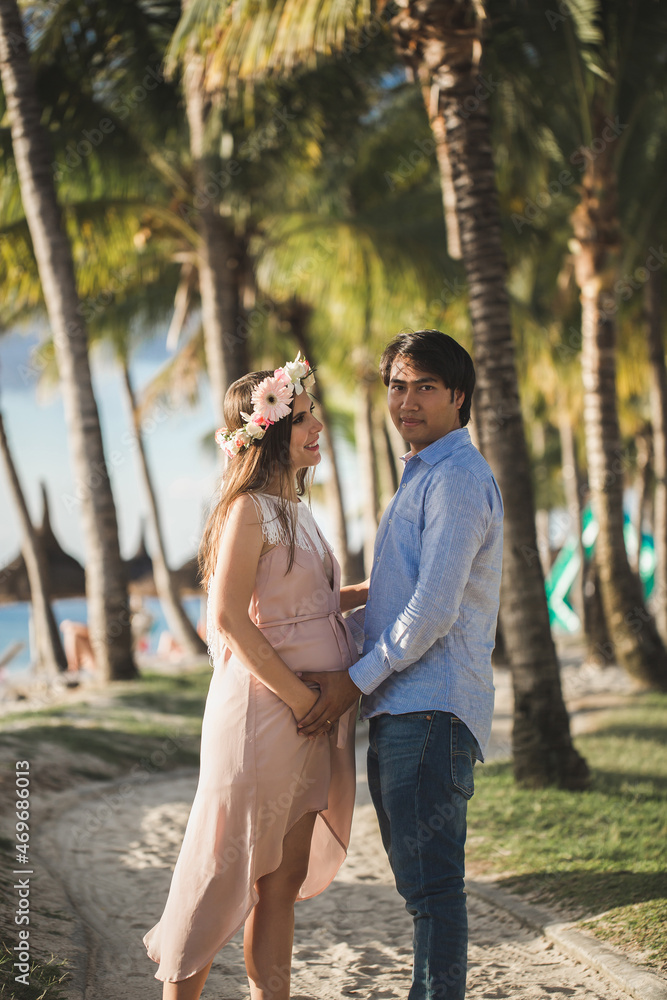 Fototapeta premium Beautiful pregnant girl and man on the beach