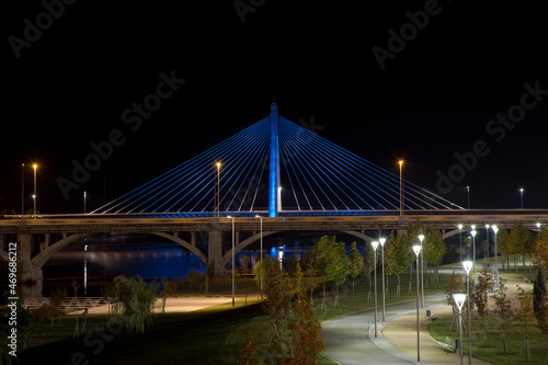Night And Panoramic Photography Of The Spanish City Of Badajoz-Extremadura. Night Landscape Of A Lighted Bridge With The Guadiana River. Horizon.