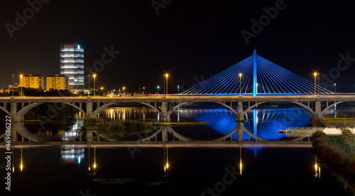 Night And Panoramic Photography Of The Spanish City Of Badajoz-Extremadura. Night Landscape Of A Lighted Bridge With The Guadiana River. Horizon. photo