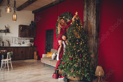 Caucasian loving couple decorating Christmas tree together