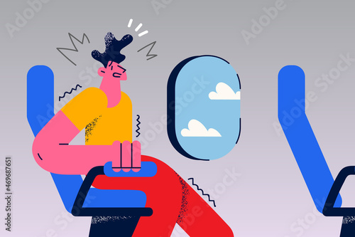 Stressed man in plane feel scared of flying 