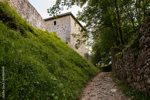 Litice nad Orlici, Eastern Bohemia, Czech Republic, 11 September 2021:  Ruins of medieval castle on hill, old stronghold, arched entrance gate, ancient fortress at sunny day, landmark in countryside photo