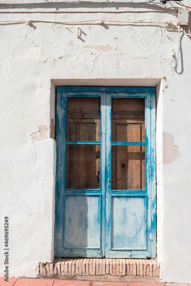 Old blue door with cracked paint.