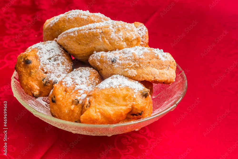 Traditional dutch oliebollen and appelflappen in a glass bowl Traditional dutch oliebollen and appelflappen in a glass bowl