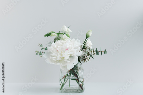 Bouquet of white flowers in a cleared vase