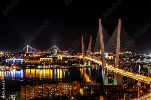 View of Vladivostok at night with the Golden Bridge and the Bridge Russian on the horizon. Far East, Russia