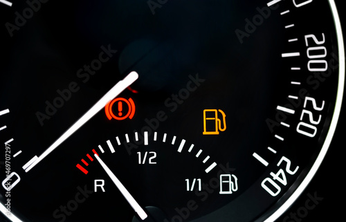 Low fuel readings on car dashboard. Fuel level indicator in reserve, no fuel
