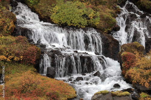 Hraunfossar, a cascade of small waterfalls flowing into the Hvita river, Vesturland, Iceland.