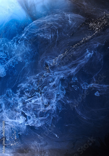 Blue smoke on black ink background, colorful fog, abstract swirling ocean sea, acrylic paint pigment underwater