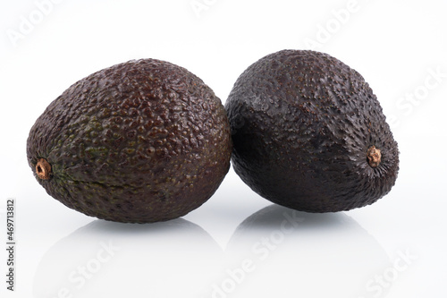 Two whole haas avocados isolated on white background, flat lay clipping path