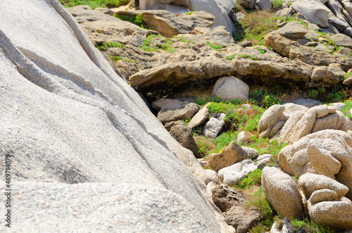 An abstraction of the human eye created by nature and consists of different types of stones among other rocks and green grass