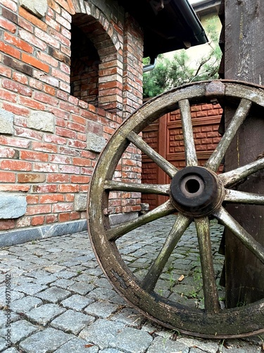 old wooden wagon wheel with decoration - Old mill in the small village