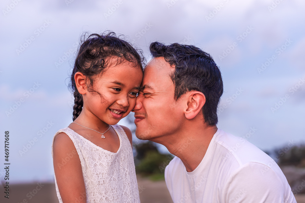 holidays, children and family concept -portrait of a little girl kissing her dad on cheek. Pretty girl giving a kiss to her father outdoor. Loving child embrace and kissing her father. holidays, children and family concept -portrait of a little girl kissing her dad on cheek. Pretty girl giving a kiss to her father outdoor. Loving child embrace and kissing her father.