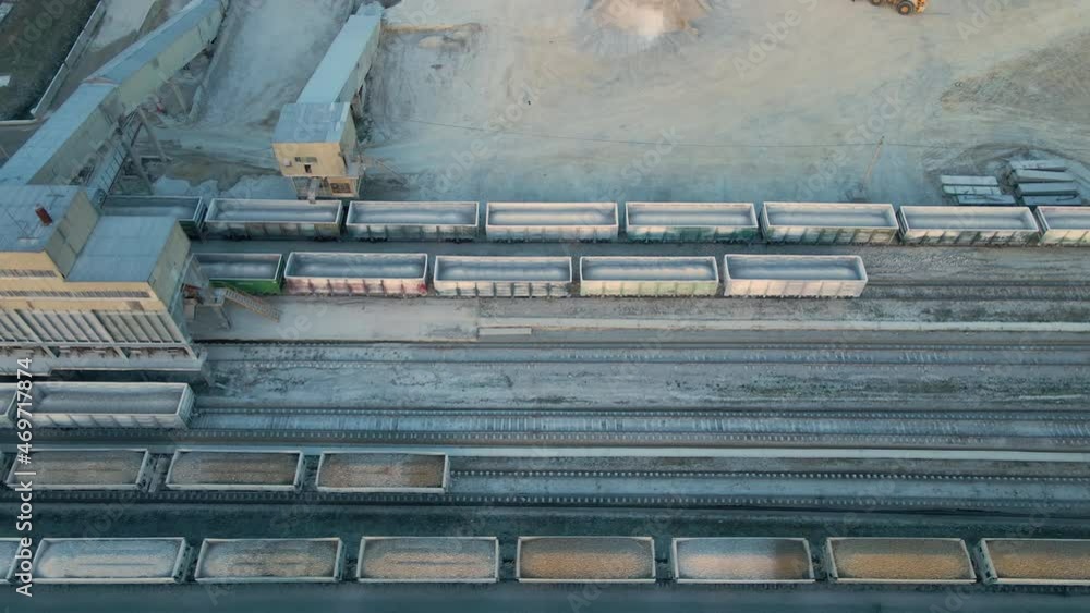 Aerial view of cargo train loaded with crushed sandstone materials at mine factory. Railway transportation of open pit mining ore Aerial view of cargo train loaded with crushed sandstone materials at mine factory. Railway transportation of open pit mining ore