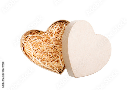 Top view of natural color open heart shape cardboard box with shredded wood excelsior for filling inside. Natural sustainable material for wrapping or products background. Isolated on white.